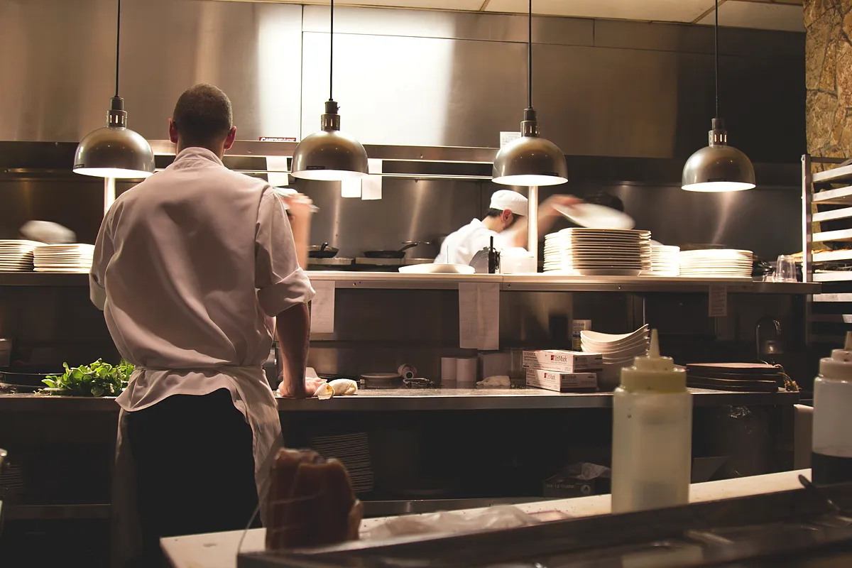 Open restaurant kitchen with chefs at work